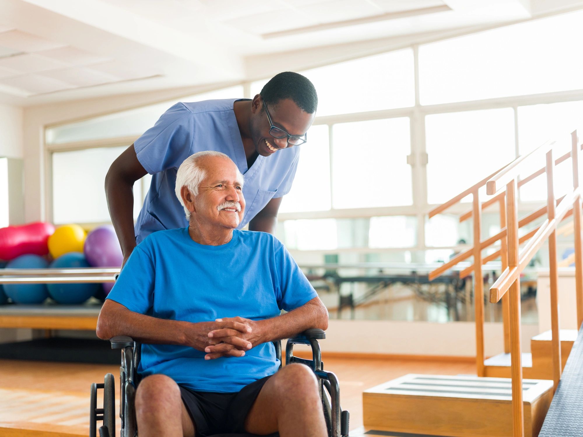 Caregiver assisting a senior resident in a wheelchair